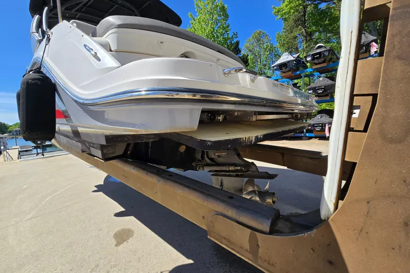 Slide: The Image of 2022 Sea Ray SLX 280 boat on a lift, showcasing sleek design and propeller. - 5
