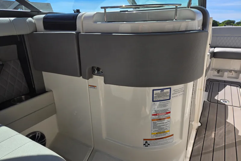 Slide: The Image of Interior view of a 2022 Sea Ray SLX 280 boat, featuring seating and safety labels. - 51