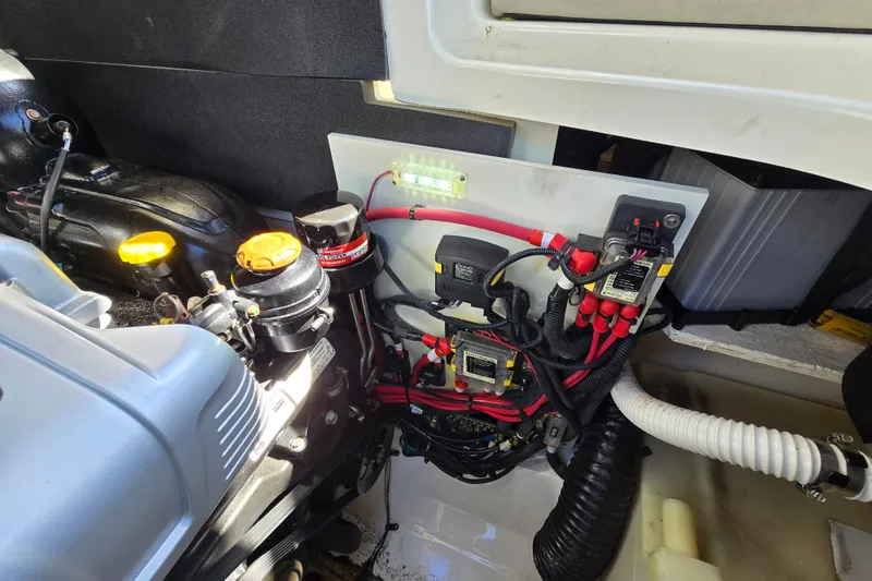 Slide: The Image of Engine compartment of a 2022 Sea Ray SLX 280 boat, showcasing wiring and components. - 54