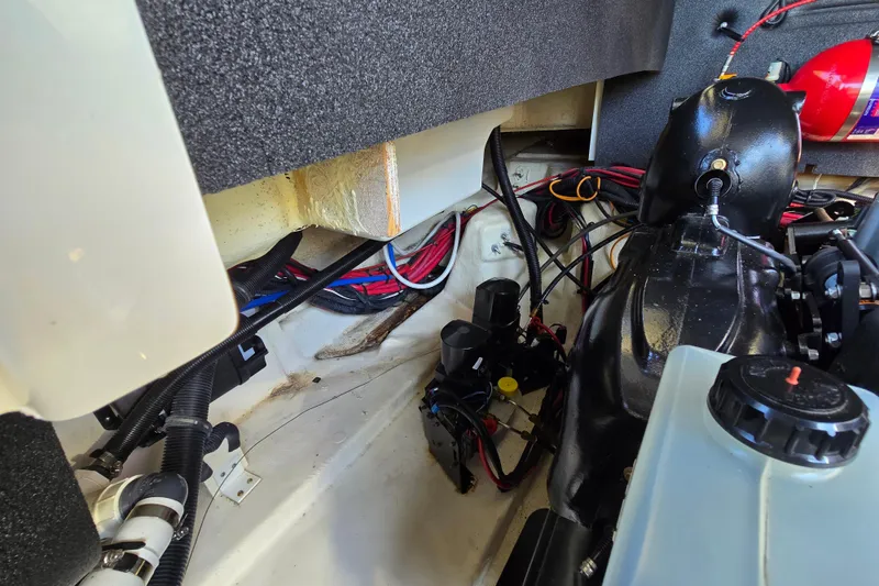 Slide: The Image of Engine compartment of a 2022 Sea Ray SLX 280 boat, showcasing wiring and components. - 56