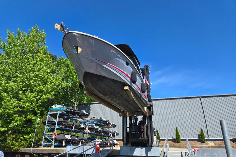 Slide: The Image of 2022 Sea Ray SLX 280 boat on lift, surrounded by trees and clear blue sky. - 7