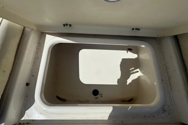 Slide: The Image of 2017 NauticStar 211 Angler boat storage compartment, open and empty. - 11