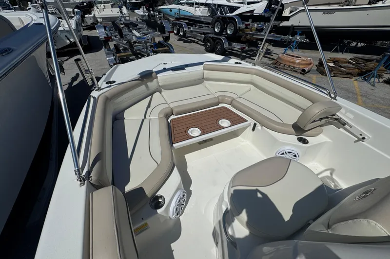 Slide: The Image of 2017 NauticStar 211 Angler boat interior with cushioned seating and cup holders. - 12