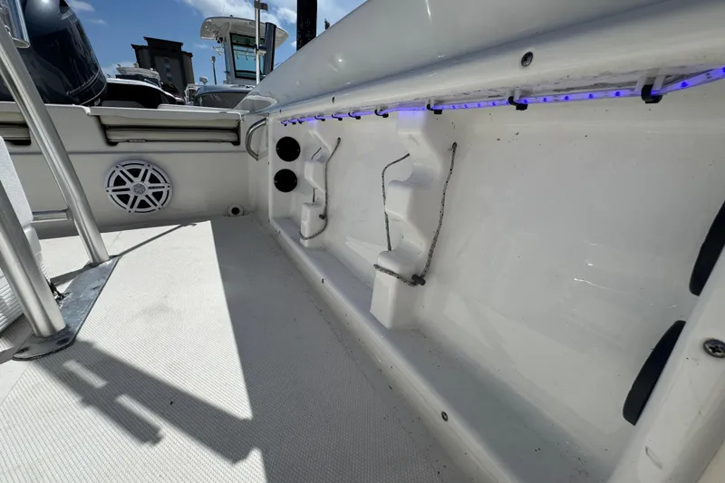 Slide: The Image of 2017 NauticStar 211 Angler boat interior with blue LED lights and speaker. - 15