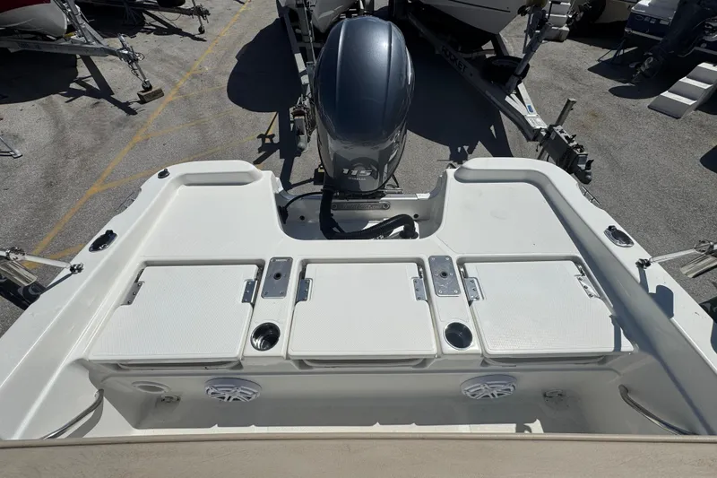 Slide: The Image of 2017 NauticStar 211 Angler boat with outboard motor and storage compartments. - 16