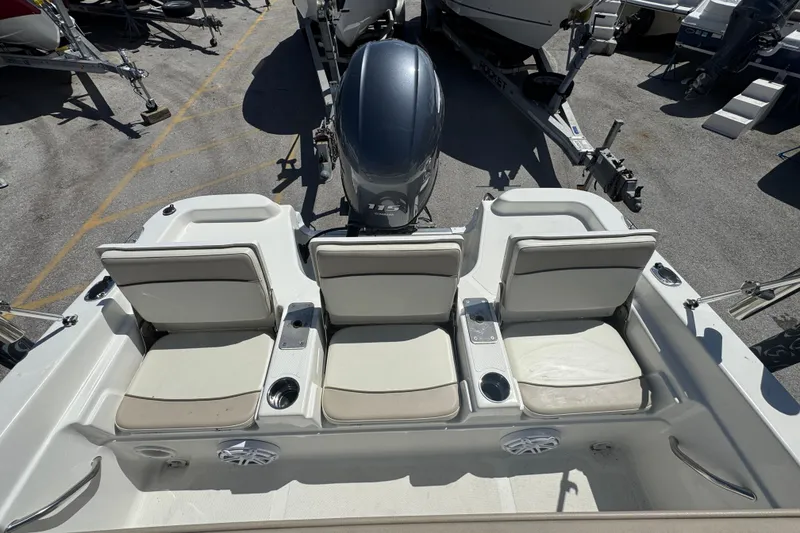 Slide: The Image of 2017 NauticStar 211 Angler boat interior with seating and motor view. - 17