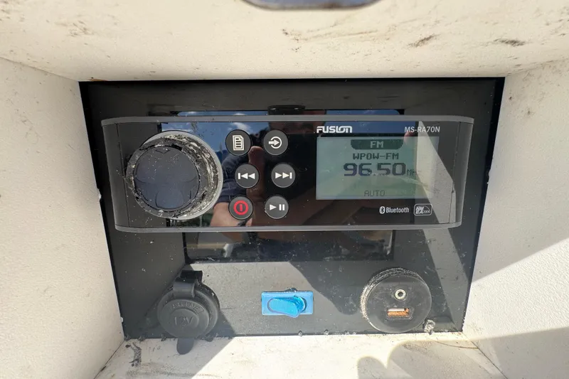 Slide: The Image of Fusion MS-RA70N radio on 2017 NauticStar 211 Angler, tuned to 96.5 FM. - 2