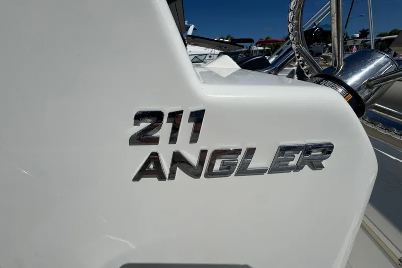 Slide: The Image of 2017 NauticStar 211 Angler boat emblem in shiny chrome finish. - 20