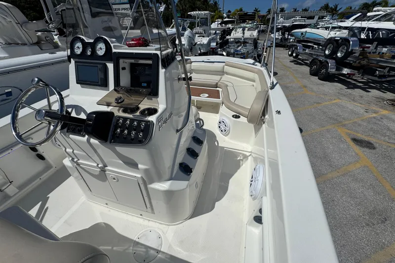 Slide: The Image of 2017 NauticStar 211 Angler boat interior with steering console and seating area. - 6