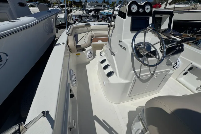 Slide: The Image of 2017 NauticStar 211 Angler boat interior with steering console and seating. - 7