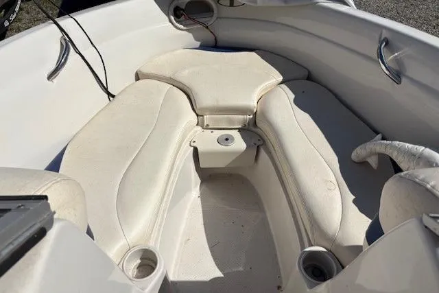 Slide: The Image of 2008 Tahoe Q6 SF boat interior with white cushioned seating and cup holders. - 10