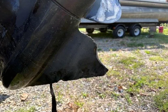 Slide: The Image of Damaged propeller of a 2008 Tahoe Q6 SF boat on a trailer. - 14