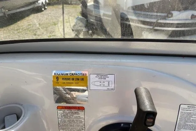 Slide: The Image of 2008 Tahoe Q6 SF boat dashboard with capacity label for 9 persons or 1700 lbs. - 6