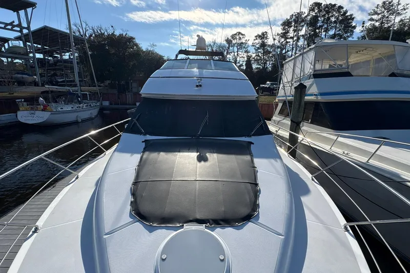 Slide: The Image of 1999 Carver 530 Voyager Pilothouse yacht docked at marina under blue sky. - 18