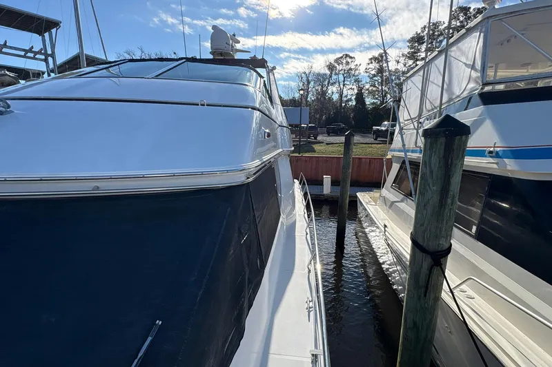 Slide: The Image of 1999 Carver 530 Voyager Pilothouse yacht docked at marina, side view. - 19
