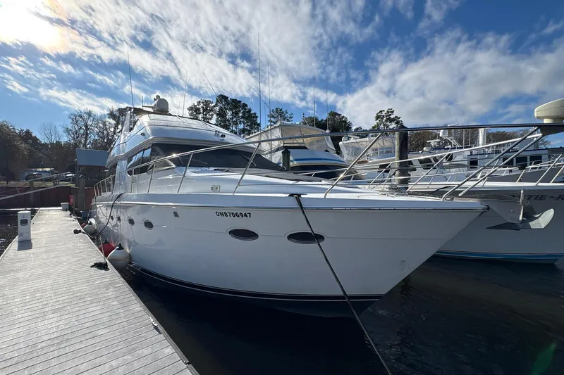 Slide: The Image of 1999 Carver 530 Voyager Pilothouse yacht docked under a clear blue sky. - 7
