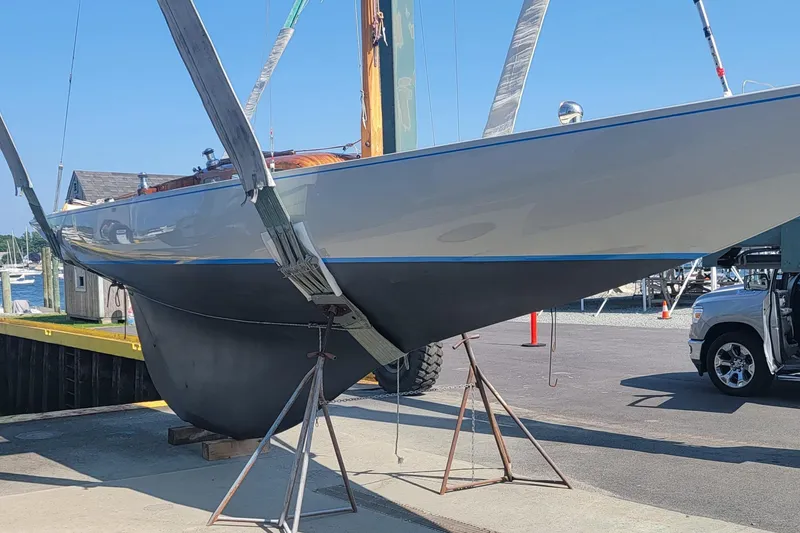 Slide: The Image of 1944 Luders 24 sailboat in dry dock, showcasing sleek hull design and classic craftsmanship. - 11