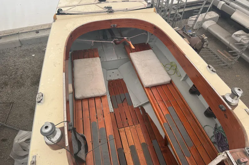 Slide: The Image of Interior of a 1944 Luders 24 sailboat with wooden seating and cushions. - 15