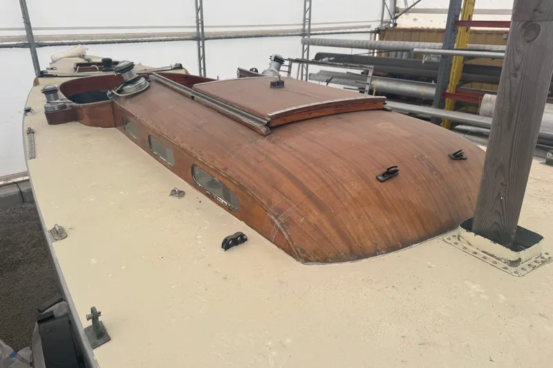 Slide: The Image of 1944 Luders 24 sailboat with wooden cabin top, stored indoors. - 17