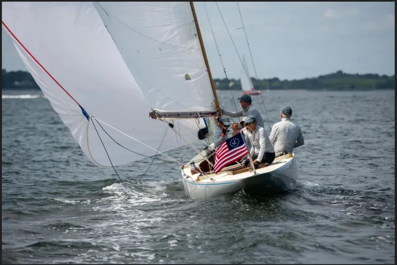 Slide: The Image of Sailing on a 1944 Luders 24 boat with American flag, open waters, and crew. - 3