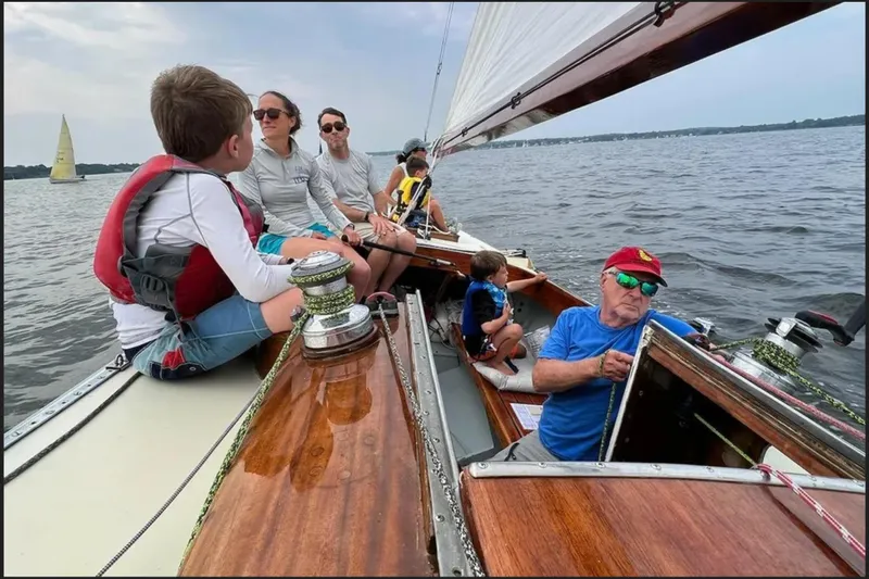 Slide: The Image of Sailing on a 1944 Luders 24 boat with family enjoying the water. - 5