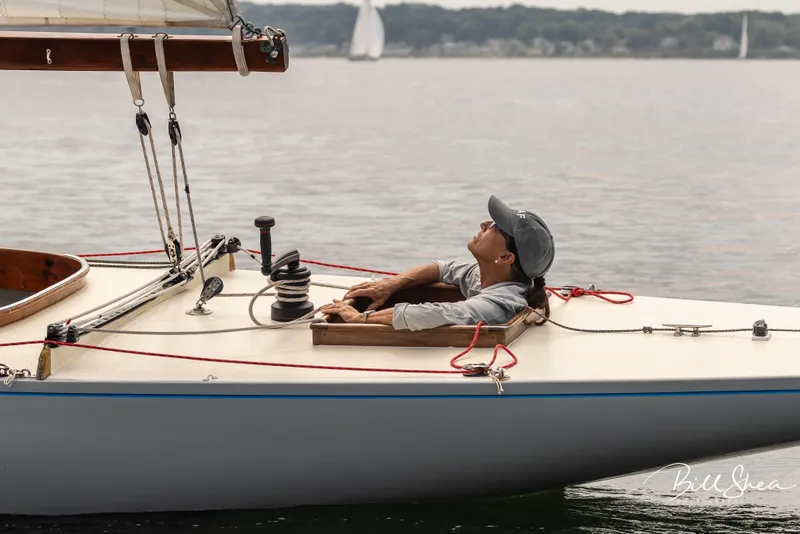 Slide: The Image of Sailor relaxing on a 1944 Luders 24 sailboat, enjoying a calm day on the water. - 7