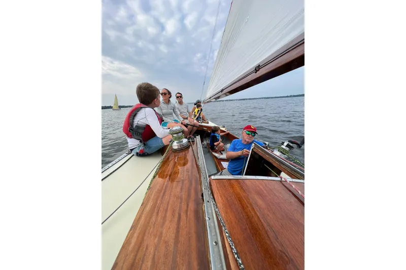 Slide: The Image of Sailing on a 1944 Luders 24 yacht with a group enjoying the open water. - 9
