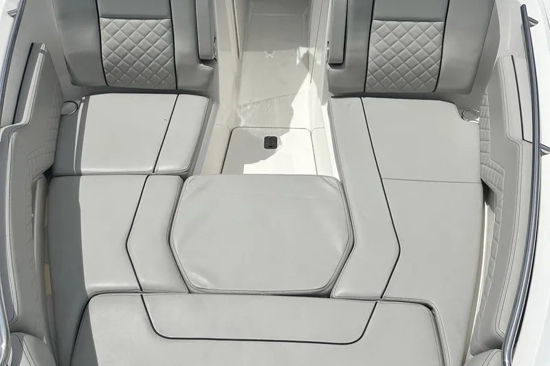 Slide: The Image of 2023 Pursuit DC 295 Dual Console boat interior with gray cushioned seating. - 10