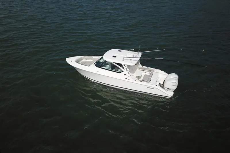 Slide: The Image of 2023 Pursuit DC 295 Dual Console boat on open water, aerial view. - 2