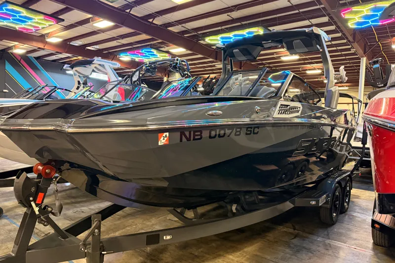 The Image of 2024 Supra SA boat in showroom with vibrant lighting and sleek design. - 1