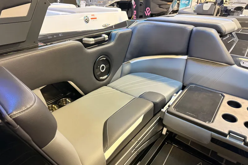 Slide: The Image of 2024 Supra SA boat interior with sleek seating, cup holders, and integrated speaker system. - 5