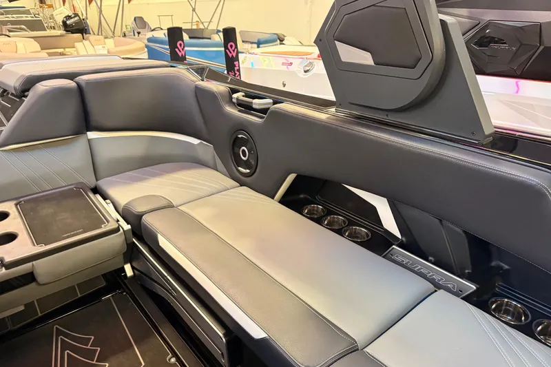 Slide: The Image of 2024 Supra SA boat interior with sleek seating, cup holders, and modern design elements. - 6