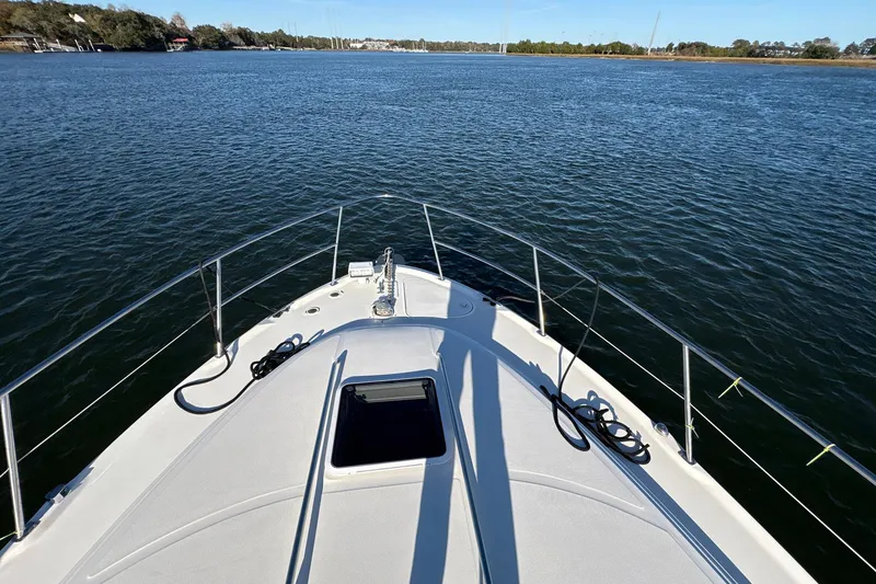 Slide: The Image of Bow view of 1999 Sea Ray 380 Sundancer on calm water. - 15