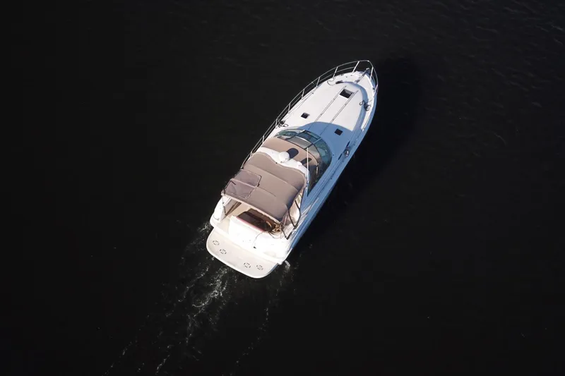 Slide: The Image of Aerial view of 1999 Sea Ray 380 Sundancer yacht cruising on dark water. - 29
