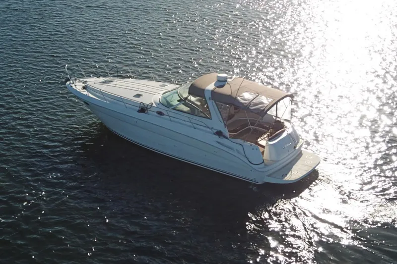 Slide: The Image of 1999 Sea Ray 380 Sundancer yacht cruising on sparkling water. - 3