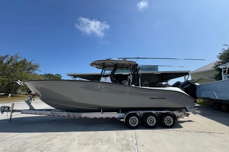 The Image of 2025 Cape Horn 32 XS boat on trailer under clear blue sky. - 1