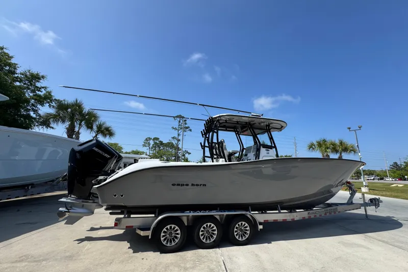 Slide: The Image of 2025 Cape Horn 32 XS boat on trailer under clear blue sky. - 10