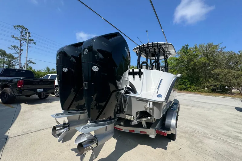 Slide: The Image of 2025 Cape Horn 32 XS boat with dual outboard motors on trailer. - 12