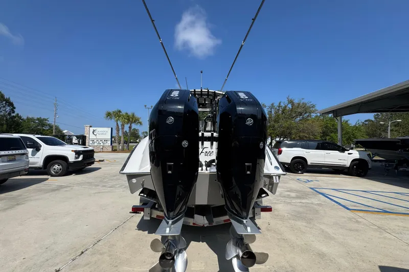 Slide: The Image of 2025 Cape Horn 32 XS boat with dual outboard engines in a parking lot. - 14