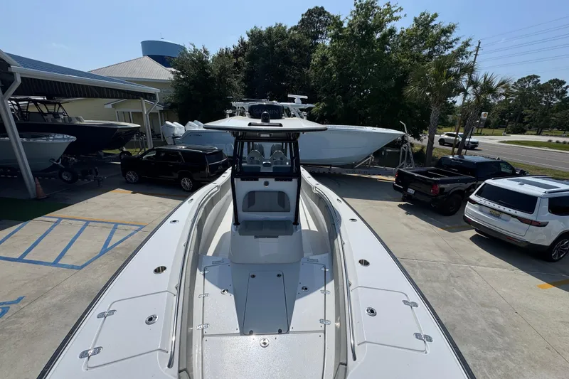 Slide: The Image of 2025 Cape Horn 32 XS boat in a dealership lot with surrounding vehicles. - 22