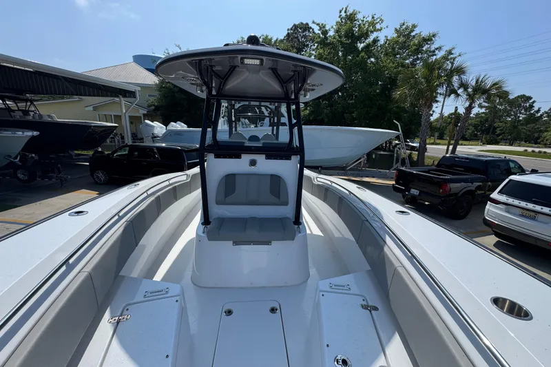 Slide: The Image of 2025 Cape Horn 32 XS boat with spacious deck and seating, parked outdoors. - 23
