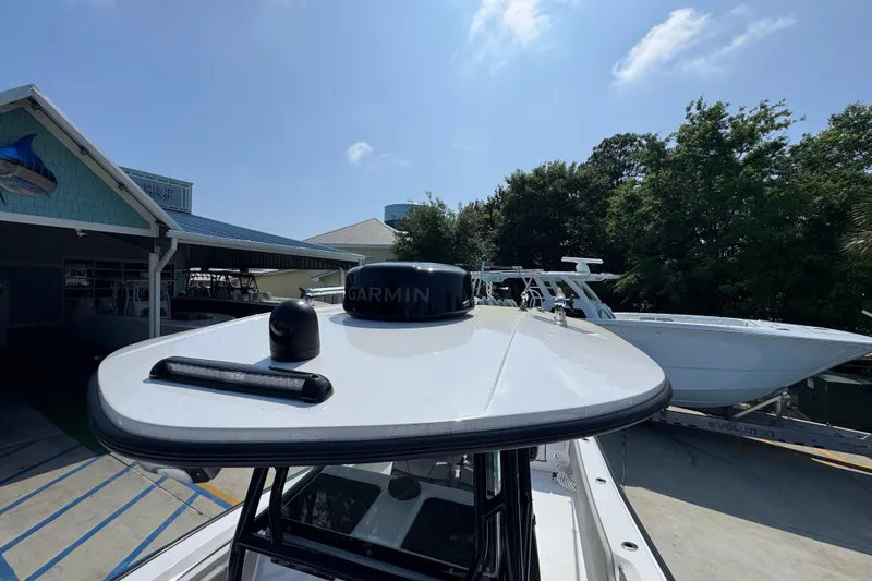 Slide: The Image of 2025 Cape Horn 32 XS boat with Garmin equipment, docked near a marine facility. - 24