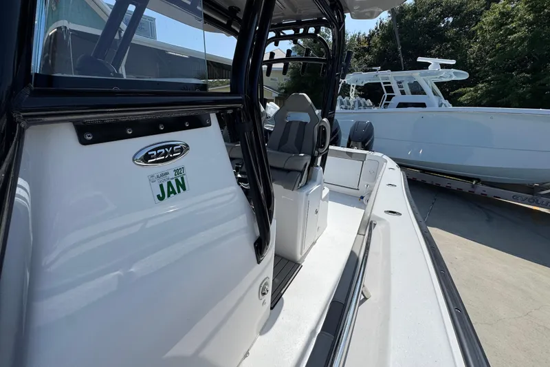 Slide: The Image of 2025 Cape Horn 32 XS boat interior with seating, docked outdoors. - 25