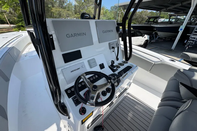 Slide: The Image of 2025 Cape Horn 32 XS boat cockpit with Garmin navigation and Mercury controls. - 28