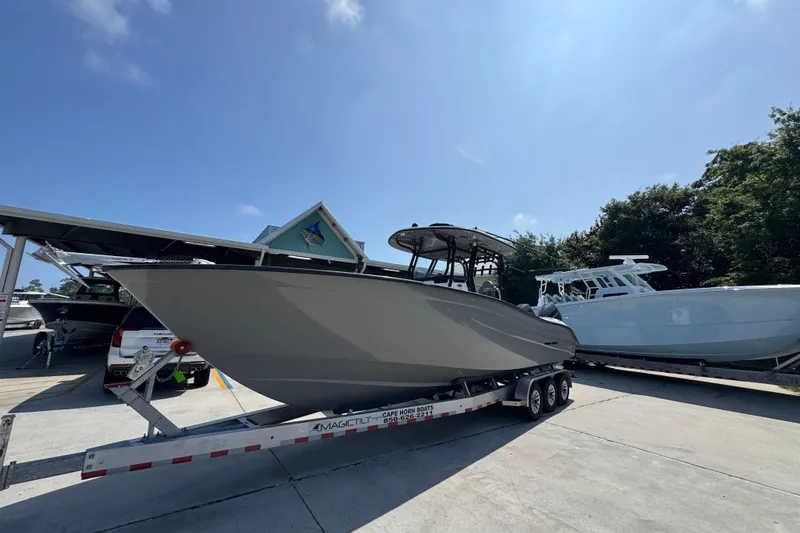 Slide: The Image of 2025 Cape Horn 32 XS boat on trailer under clear blue sky. - 3