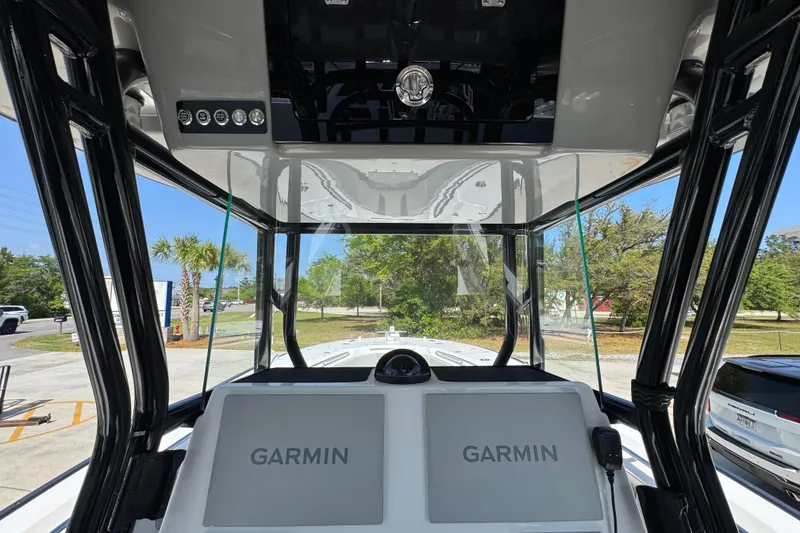 Slide: The Image of 2025 Cape Horn 32 XS boat cockpit with dual Garmin displays and sleek black frame. - 30