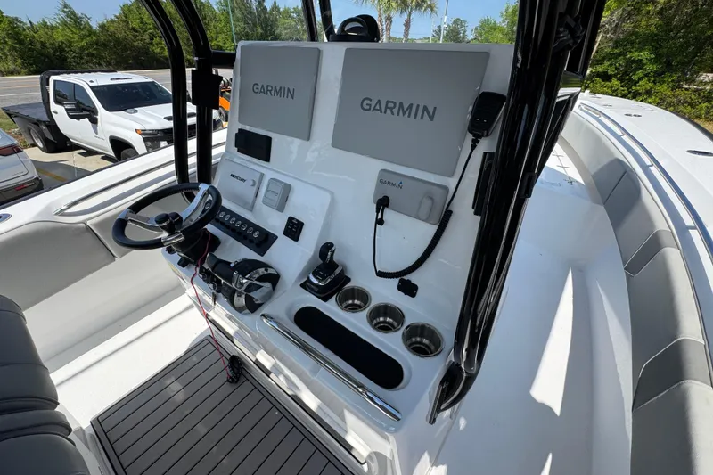 Slide: The Image of 2025 Cape Horn 32 XS boat console with Garmin navigation system and steering wheel. - 31