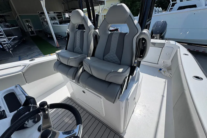 Slide: The Image of 2025 Cape Horn 32 XS boat interior with dual gray captain seats. - 32