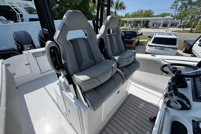 Slide: The Image of 2025 Cape Horn 32 XS boat interior with dual gray captain seats and steering console. - 35