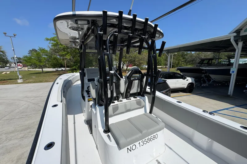 Slide: The Image of 2025 Cape Horn 32 XS boat with seating and rod holders, parked outdoors. - 36